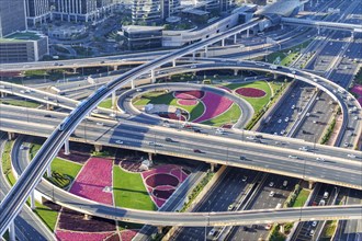 Intersection of Sheikh Zayed Road traffic on the road near the Burj Khalifa with Metro in Dubai,