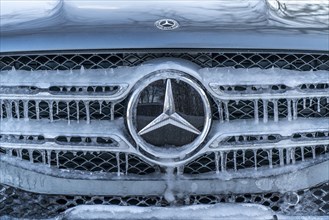 Winter weather, radiator of a vehicle with icicles