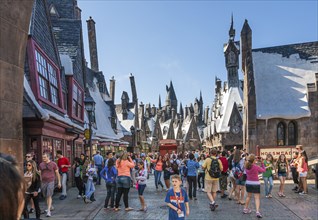 Park guests pose for photographs in The Wizarding World of Harry Potter at Universal Studios,