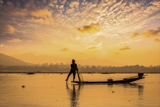 Myanmar travel attraction landmark, traditional Burmese fisherman sihouettes at Inle lake on