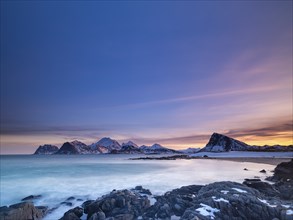 Snow-capped mountains by the sea, Vestvagoya, Lofoten, Norway, Europe