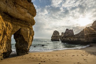 Rocky coast with beach and red rocks, Praia do Camilo, Lagos, Algarve, Portugal, Europe