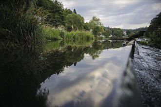 Symbolic photo. Clouds are reflected in the barrage of the Saale in Ziegenrück. Ziegenrück, 20.07