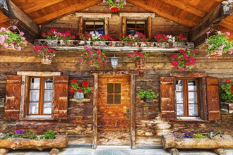 Old wooden house with floral decorations, historic village centre, Grimentz, Val d'Anniviers,