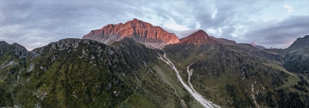 Panorama, rocky mountain peak Porze and green mountain landscape with river valley at sunrise,