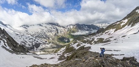 Mountaineer on hiking trail with snow, mountain landscape with summit Hoher WeiÃŸzint and