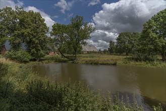 Manor house from 1920, in front the fire pond, in the back former horse stable and large barn,