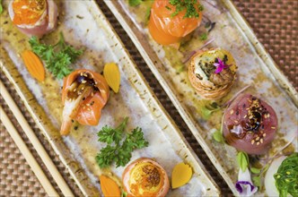 Platter decorated with different flavors of elegant sushi. Selective focus