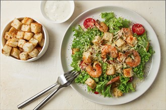 Caesar salad, with shrimp, on a white background, homemade, no people