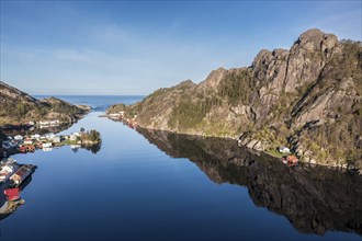 Aerial view over fjord at Ana Sira at the norwegian southern coast, lonely houses at the foot of a