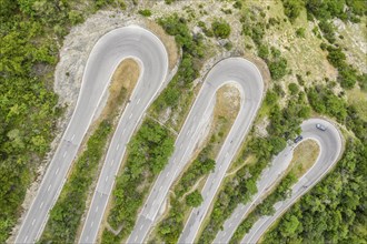 Aerial view, drone shot, Mountain pass road with multiple hairpins, water pipeline, Switzerland,