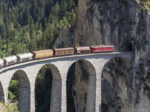 Freigth train passing the Landwasserviadukt near Filisur, Switzerland, Europe