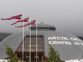 Norwegian flags in strong wind, arctic circle center, polar circle, E6 highway, Norway, Europe