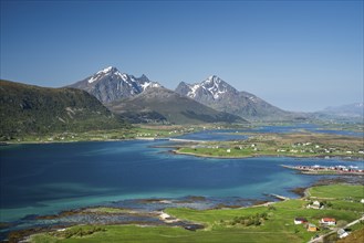 Landscape with sea and mountains, view from Hornsheia to Mount Himmeltindan. Good weather, blue sky