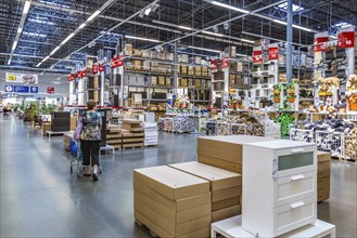 Female customer shopping inside the warehouse section of an Ikea store in the USA