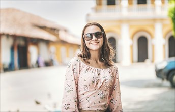 Portrait of beautiful tourist girl in a tourist square. Granada, Nicaragua. Portrait of smiling