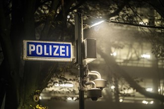 Illuminated sign for a police station, surveillance cameras for the police station car park, North