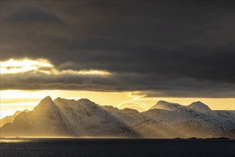 Light mood over steep mountains, coast, view of Vestvagoya, Lofoten, Norway, Europe