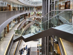 Stilwerk Düsseldorf, free-floating staircase in the elliptical atrium with surrounding galleries on
