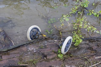 Symbolic image, environmental pollution, wheels with axle of pram, BASF, Lugwigshafen am Rhein,