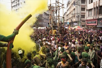 Revellers dancing in the beat of music as they celebrate Holi on a street, the Hindu spring