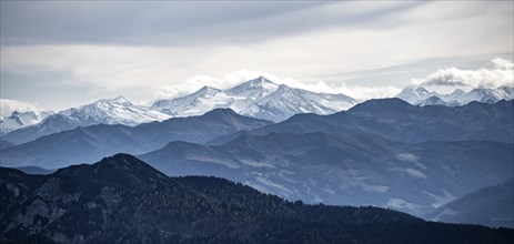 View of the Alpine foothills and the main Alpine ridge with snow-covered peaks, from the Austrian