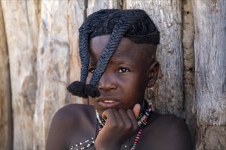 Himba girl with braids plaited to the front, portrait, near Opuwo, Kaokoveld, Kunene, Namibia,