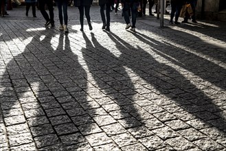 Pedestrians in a pedestrian zone, winter, long shadows, Dortmund, North Rhine-Westphalia, Germany,