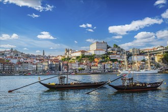 View of Porto city and Douro river with traditional boats with port wine barrels and sailing ship