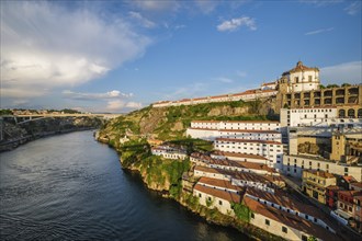 View of Vila Nova de Gaia city with Mosteiro da Serra do Pilar monastery and Douro river on sunset.