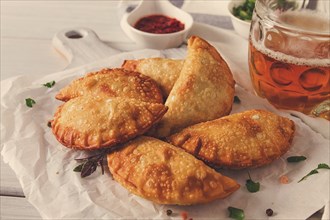 Fried chebureks, close-up, on a light background, no people