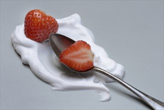 Strawberries with cream on a spoon