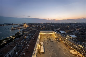 Evening atmosphere, illuminated Basilica di Santa Maria della Salute and St Mark's Square, view