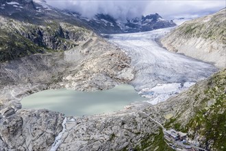 Drone shot of melting Rhone glacier, glacial lake, origin of Rhone river, Switzerland, Europe