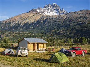 Tents on campsite in village Villa Cerro Castillo, mountain Cerro Castillo in the back, Aysen