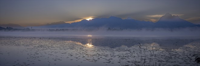 Sunrise at Lake Hopfensee near Füssen, behind Hopfen am See, the Tegelberg massif and the SÃ¤uling,