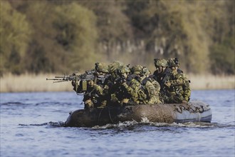 Czech and German soldiers launch an inflatable boat into the Elbe as part of the military exercise