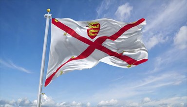 The flag of the Isle of Jersey, Great Britain flutters in the wind