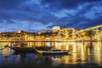 View of Porto city and Douro river with traditional boats with port wine barrels and sailing ship