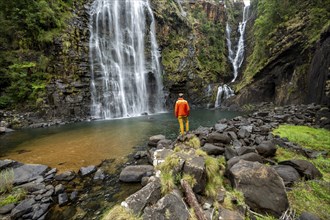 Young man standing in front of a waterfall, Lisbon Falls, long exposure, near Graskop, Mpumalanga,