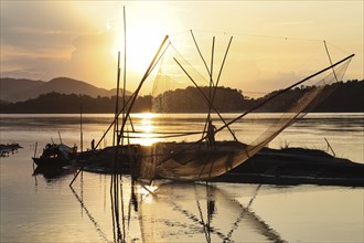 Fisherman fishing in the Brahmaputra river at sunset, in Guwahati, Assam, India on 16 June 2021