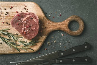 Fresh, raw rib eye steak, on a chopping board, top view, no people