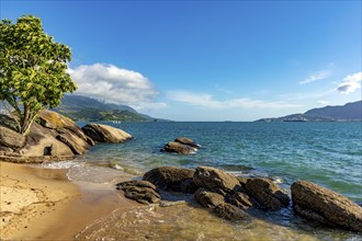 Beach on the island of Ilhabela on the north coast of Sao Paulo with the mountains in the