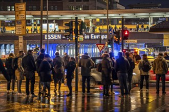 Pedestrian, in rainy weather, at a traffic light, pedestrian crossing, at the main railway station