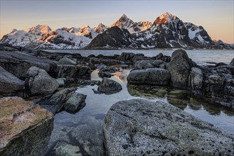 Sunrise, morning light, steep mountains by the sea, winter, Flakstadoya, Lofoten, Norway, Europe