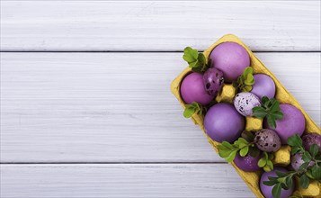 Easter eggs, purple and lilac, on a white wooden table, Easter card, banner, selective focus,