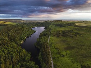 Sunset over Cod Beck Reservoir from a drone, North York Moors National Park, North Yorkshire,