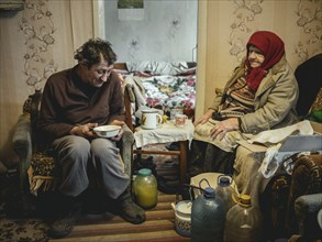 Varvara, 85, and her son Leonid, 56. Leonid looks after his mother, who is in need of care. She