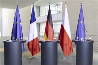 Lecterns and flags, taken during a press conference at the Federal Chancellery in Berlin, 15 March