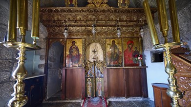 Gilded altar area with icons of saints and candlesticks, Monastery of Apokalipsis, Patmos,